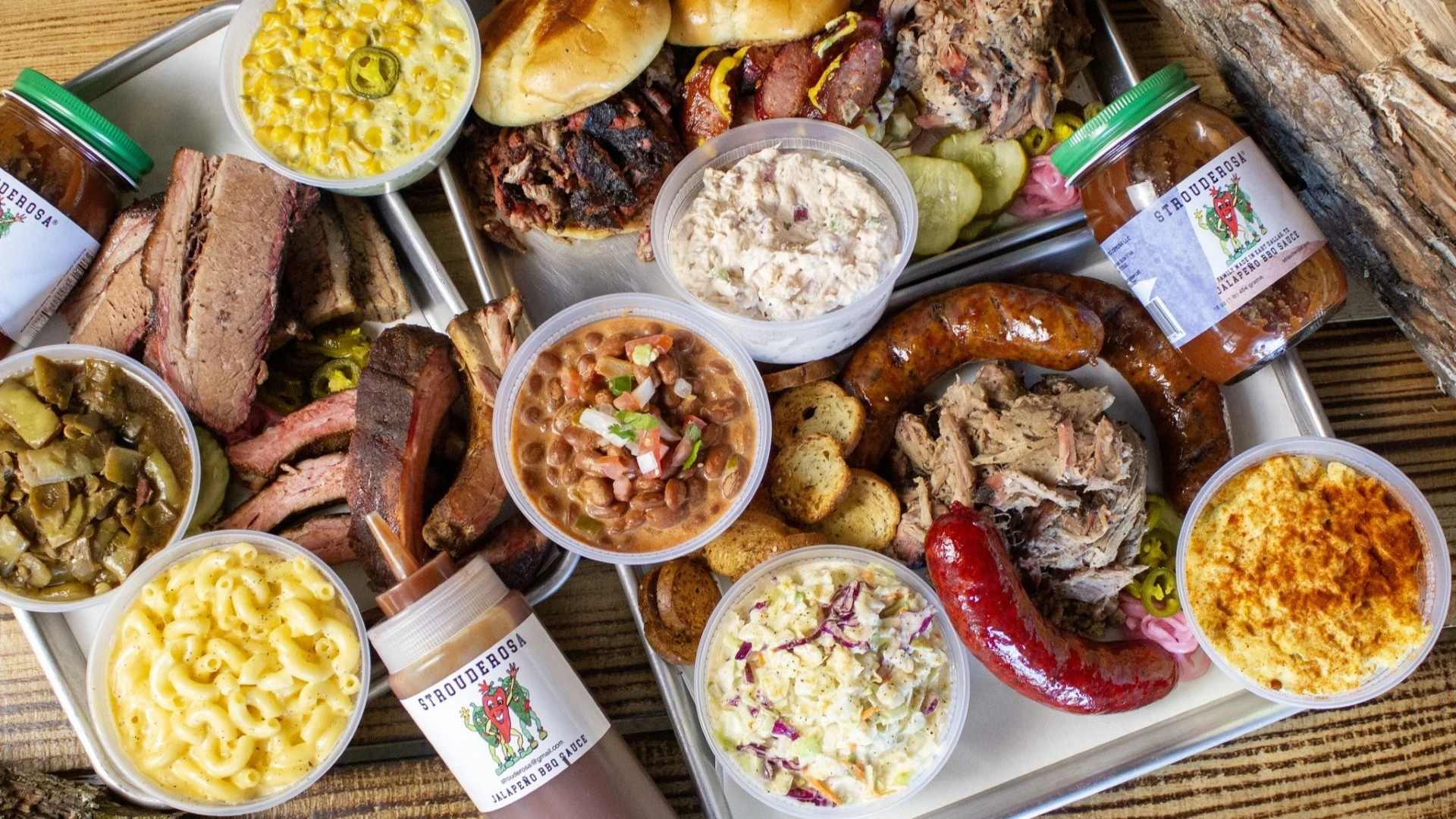 A spread of smoked meats, mac and cheese, and sides